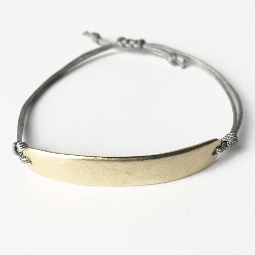When you're looking for a more substantial friendship bracelet, this is the one for you. Perfect left plain, or try it with an engraved name or a special date. Bracelet is a solid heavy 10K yellow gold bar finished with an indestructible AND adjustable  cord closure.
