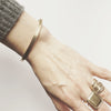 A solid 10K yellow gold elegant oval bangle bracelet which gently contours to your wrist. This piece has a nice weighty feel to it. You probably won't take it off once you put it on.